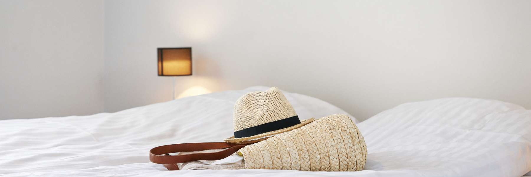 Bag with blanket and hat on bed